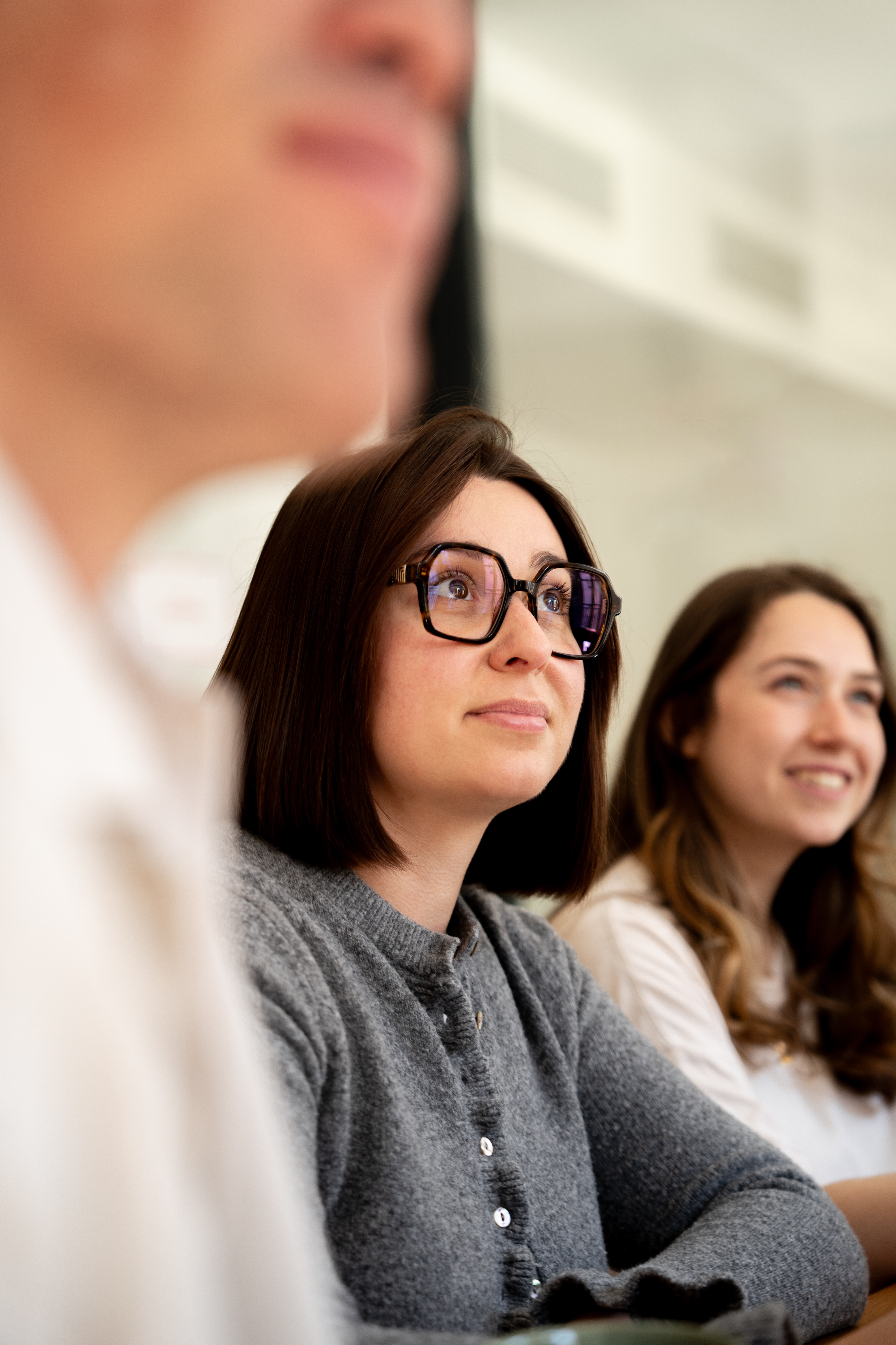 Two Galadrim team members in a workshop, listening closely to a presentation