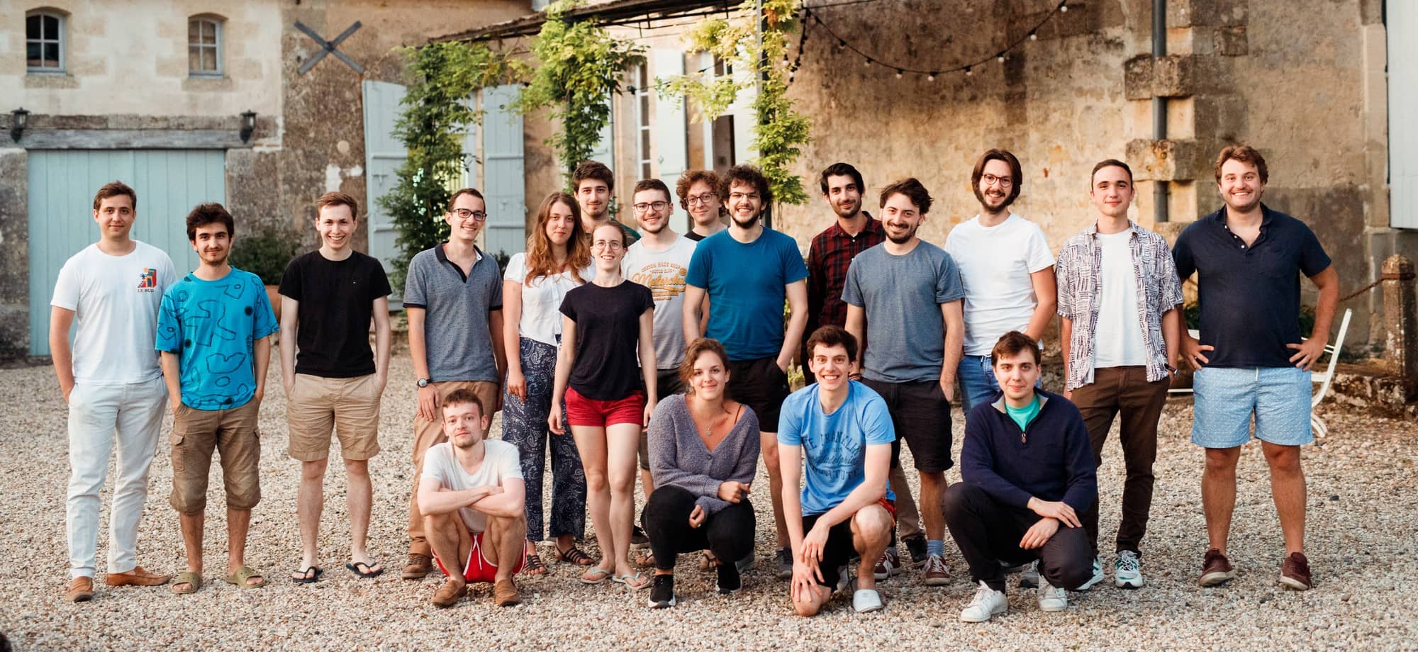 The Galadrim team gathered in the courtyard of a stone building during an offsite.